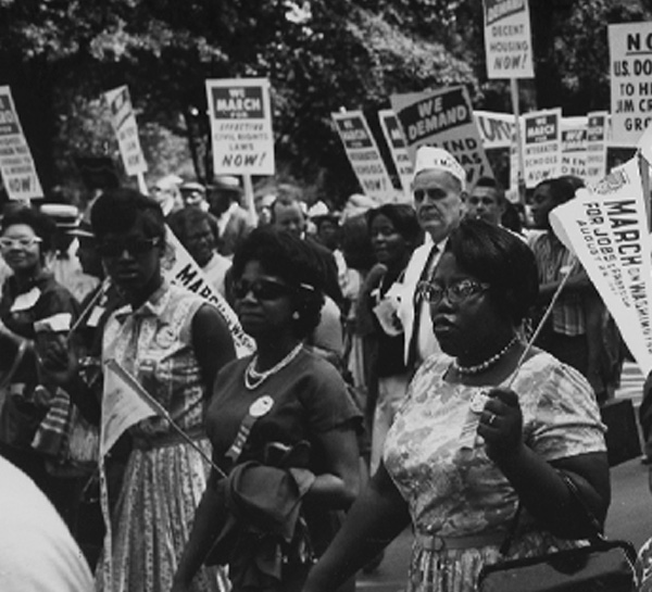 A black and white photo of women holding signs during the civil rights movement